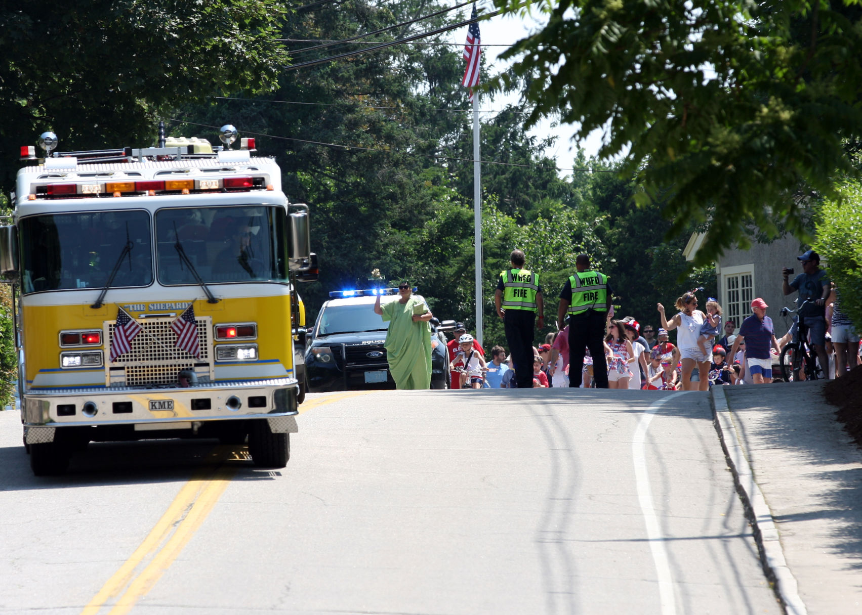 Here they come! Children and parents, led by a Watch Hill Fire Department engine